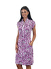 Woman wearing a purple patterned dress on a white background
