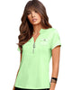 Woman wearing a light green polo shirt with a brand logo on a white background
