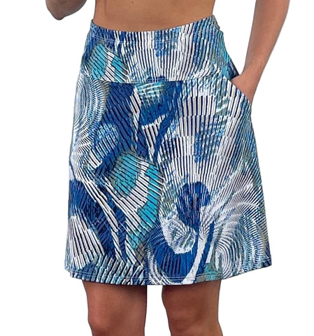 Blue and white patterned skirt worn by a person on a white background