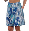 Blue and white patterned skirt worn by a person on a white background