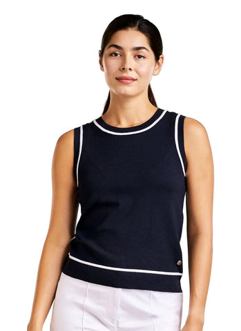 Woman wearing a navy sleeveless top with white trim on a white background