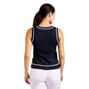 Woman wearing a navy sleeveless top with white trim on a white background