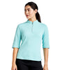 Woman wearing a light blue athletic top with a quarter zip on a white background