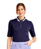 Woman wearing a navy blue polo shirt with white trim on a white background