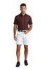 Man wearing a patterned red and black shirt and white shorts on a white background