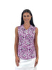 Woman wearing a sleeveless floral patterned top on a white background