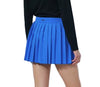 Person wearing a black jacket, blue pleated skirt, and white shoes on a white background