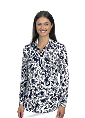 Woman wearing a patterned long-sleeve shirt and white skirt on a white background