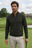 Model wearing black quarter-zip pullover on golf course