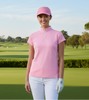 Woman in pink shirt and white pants standing on a golf course